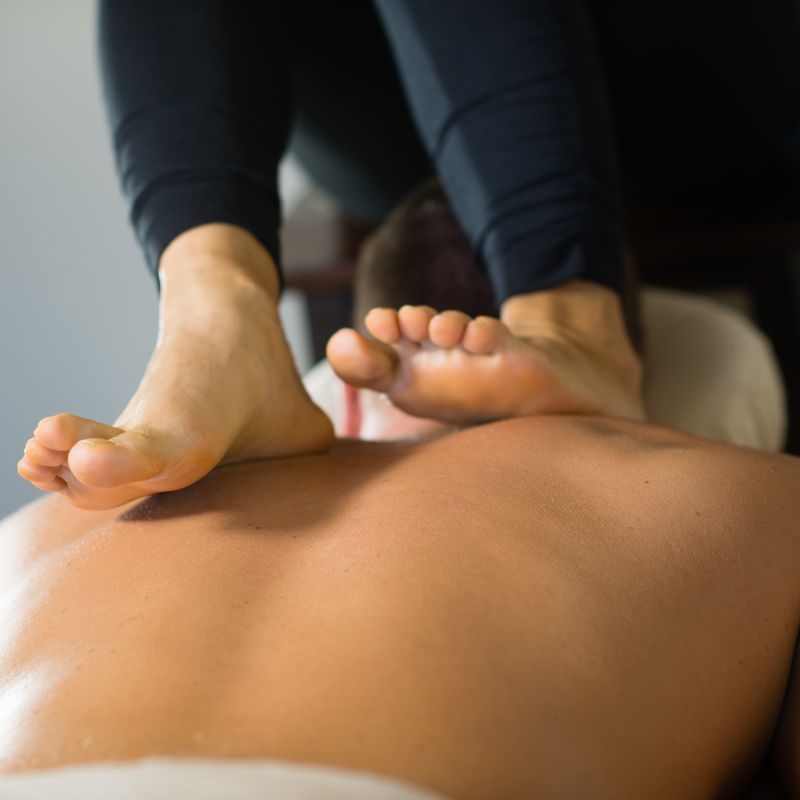 feet massaging someone's back